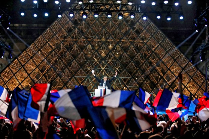 French President-elect Emmanuel Macron celebrates on the stage at his victory rally near the Louvre in Paris